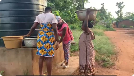 Women collecting water from a new storage tank