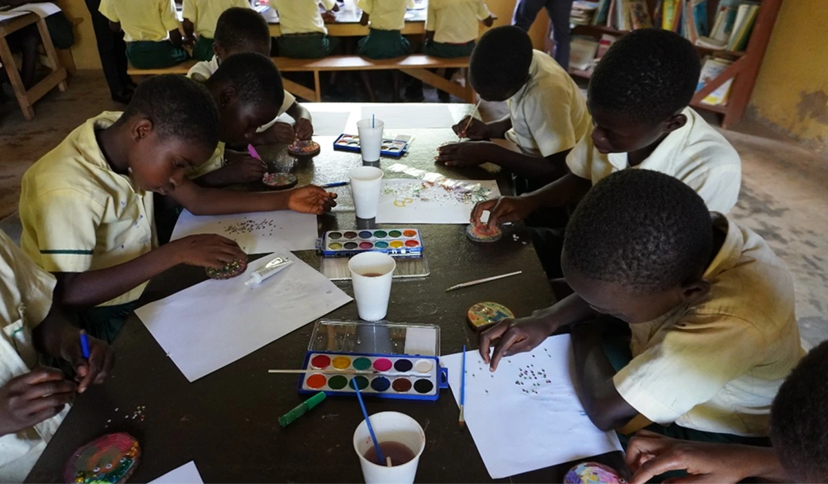 Children painting together at a table