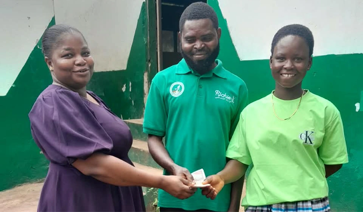 A scholarship being handed to a student